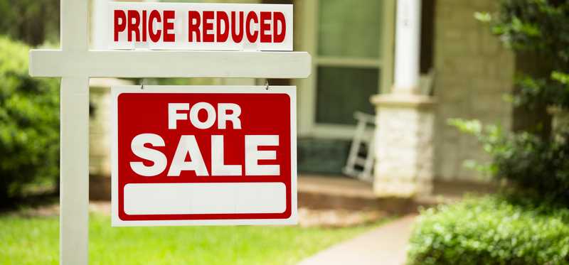 For sale sign with the words Price Reduced added.
