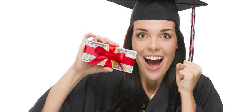 A female graduate holding gift wrapped cash.