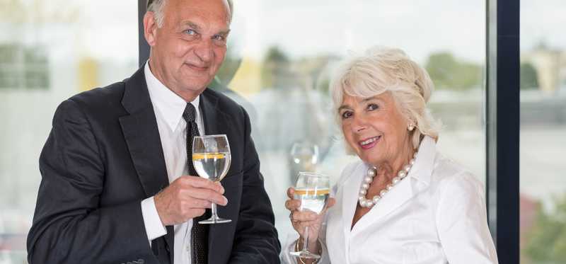 Two people holding champagne glasses.