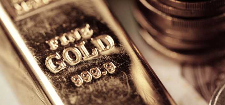 A gold bar and a stack of gold coins.