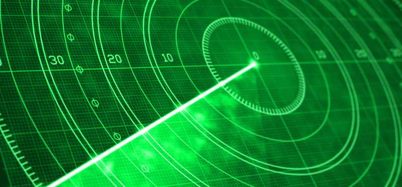Detail of a green radar screen with glowing coordinates and positioning numbers.