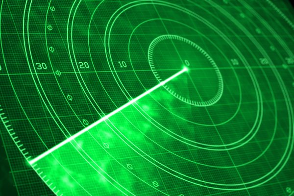 Detail of a green radar screen with glowing coordinates and positioning numbers.