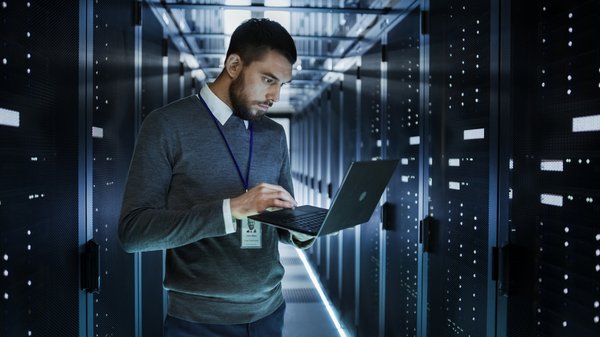 Someone using a laptop near in a data center