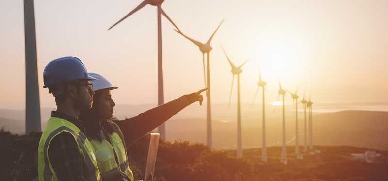 Utilities workers with wind turbines.