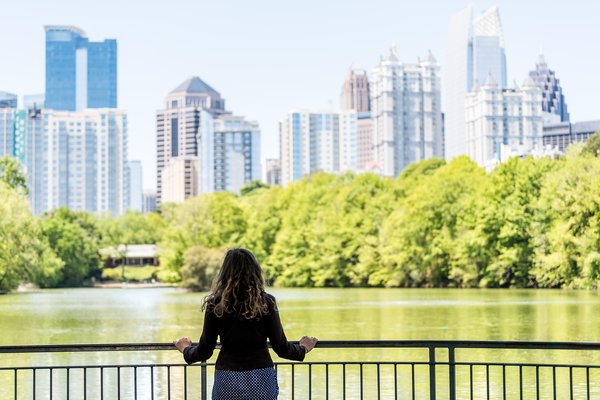 Person in park looking at the Atlanta city skyline.