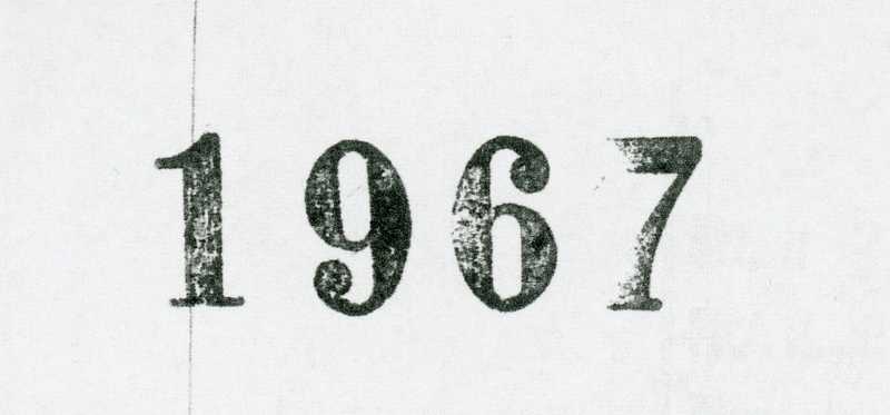 The year 1967 is typed on a piece of paper.
