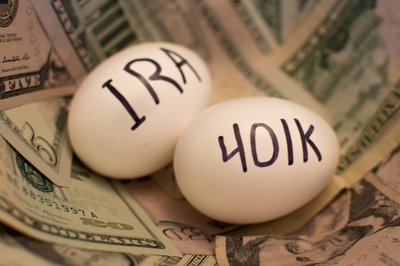 Two eggs sitting on cash are labeled IRA and 401k.