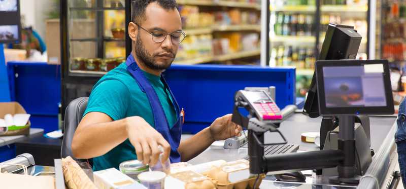 A cashier checking someone out at a supermarket