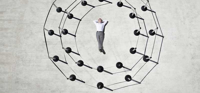 A man is lying on the ground in the middle of two circles.