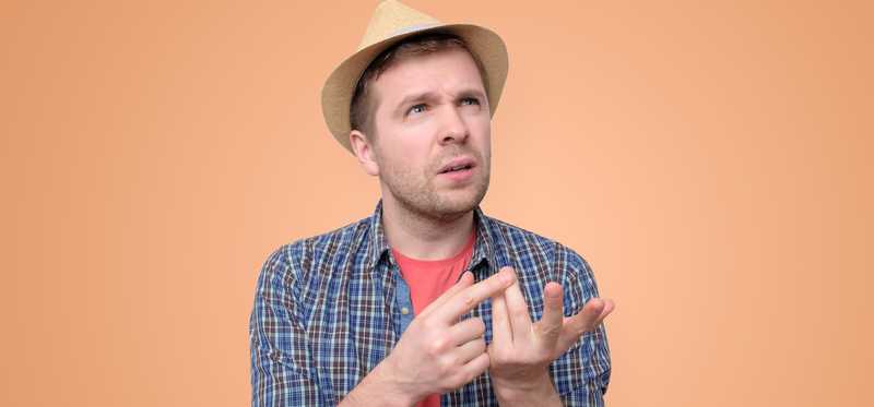 Person appears to be thinking while counting on their fingers.