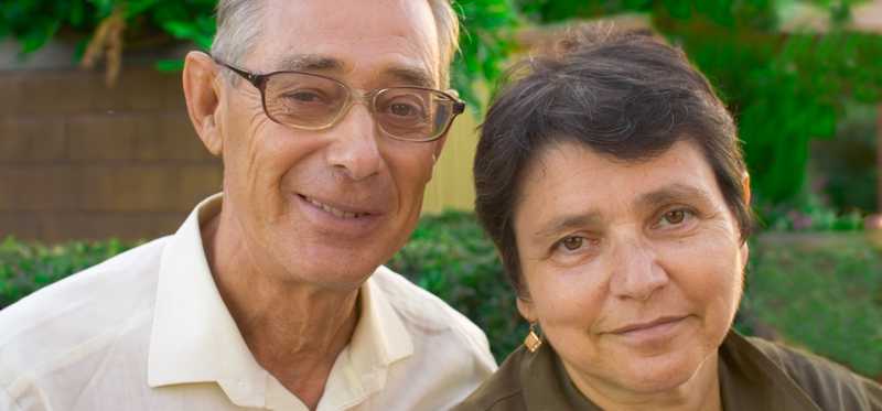 Two people smiling outdoors.