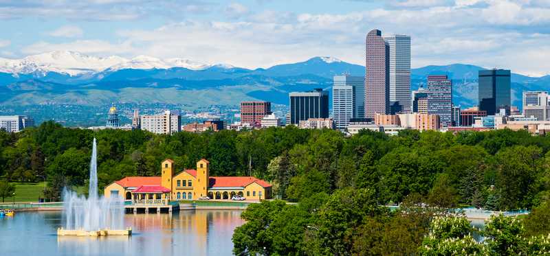Denver, Colorado, skyline with mountains in the background.