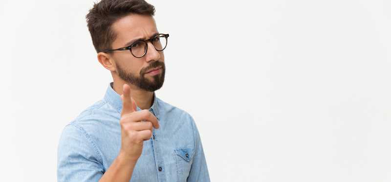 A person is pointing a finger at us as if warning us.