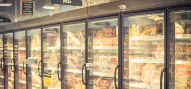 We see the frozen foods aisle of a supermarket.