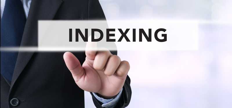 We see the hand of a man in a suit pointing to the word indexing.