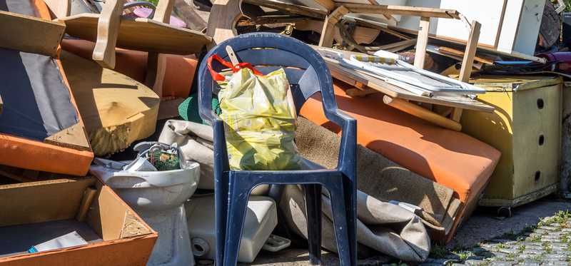 Pile of junk, including old furniture and rugs