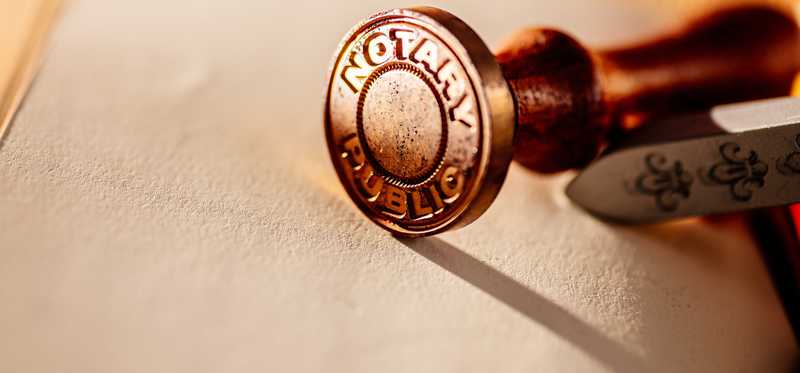A notary public stamp is shown, on its side.