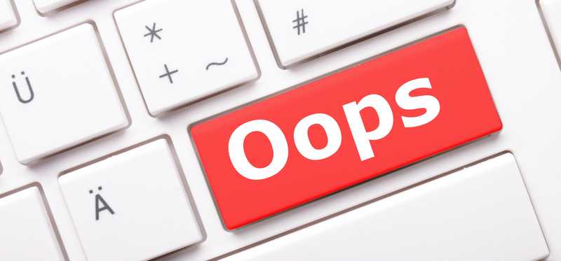 A red key on a white keyboard is labeled Oops.