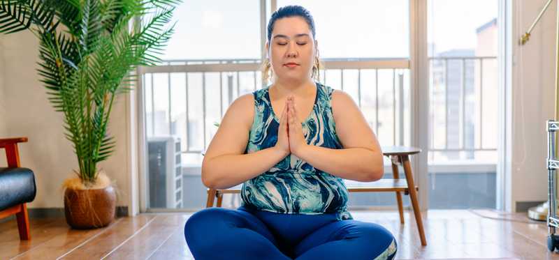 A person is meditating and appears peaceful.