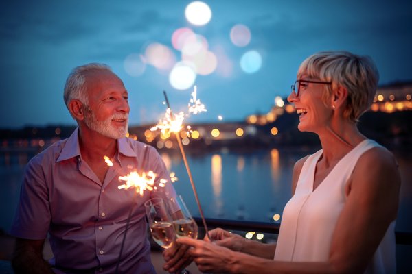 Two people celebrating with sparklers at dusk.