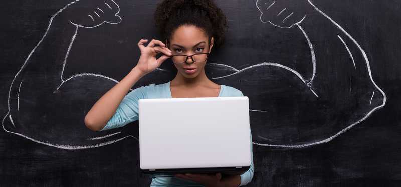 We see a young woman holding a laptop open. On the blackboard behind her are drawn big muscular arms, where her arms are.
