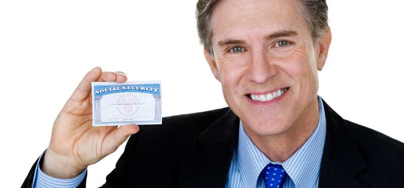 Person holding a Social Security card and smiling.