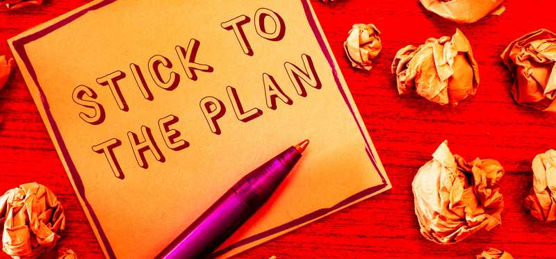 Illustration with the words Stick to the Plan surrounded by crumpled paper.