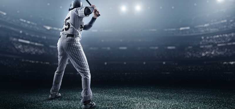 A batter in a baseball stadium is waiting for his pitch.