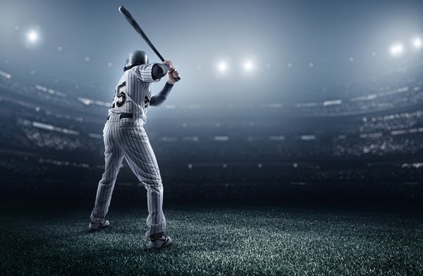 A batter in a baseball stadium is waiting for his pitch.