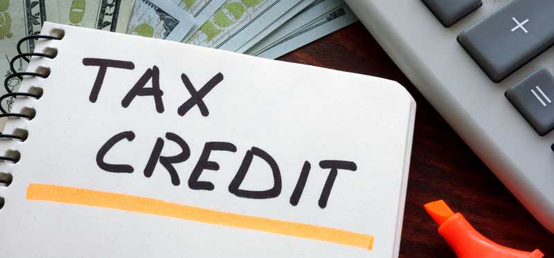 The words Tax Credit written on paper.