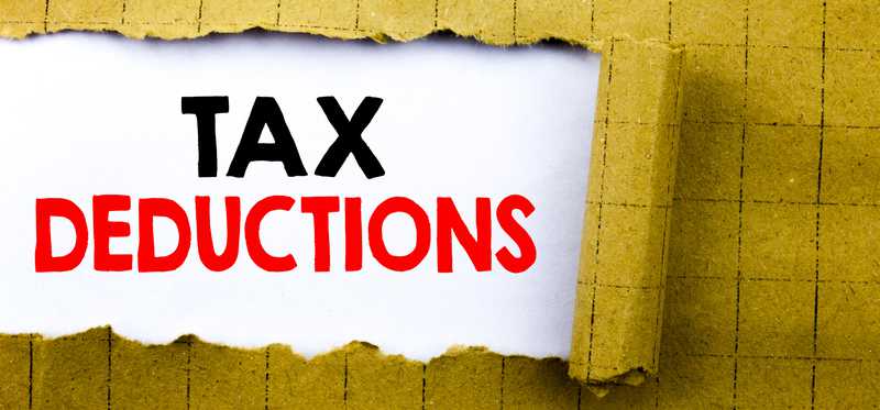 Torn paper revealing the words Tax Deductions.