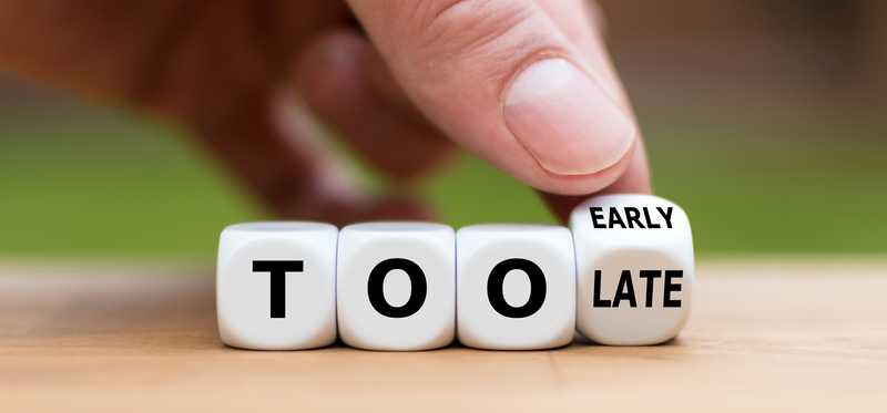 Small blocks are being turned over to spell Too Early or Too Late.