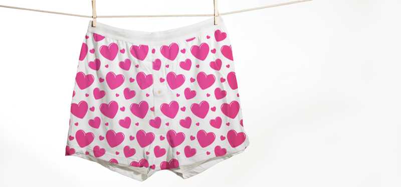 A pair of men's boxer underwear, with hearts printed on it