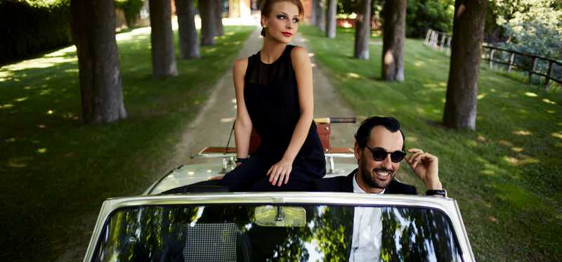 Two seemingly wealthy people in a fancy car.
