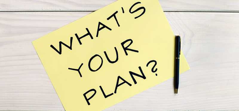 The question What's Your Plan written on a Post-it note.