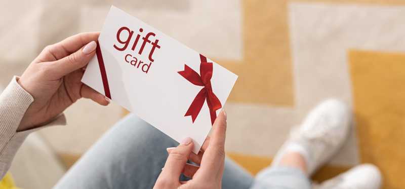 Hands holding a gift card.