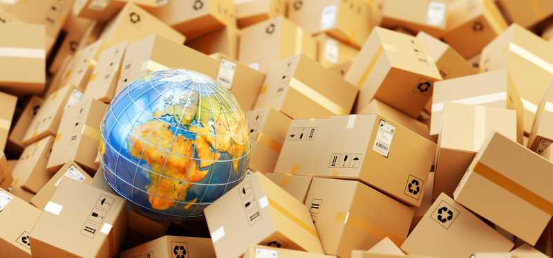 A globe sits in a pile of packages.