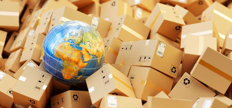 A globe sits in a pile of packages.