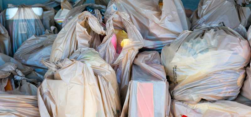 A car is packed with grocery bags.