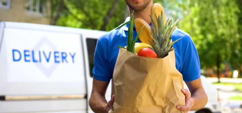 Person making a grocery delivery.