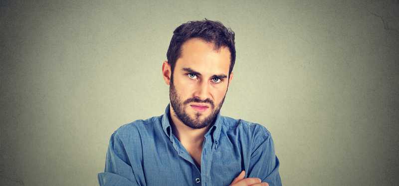 A man looks grumpy.
