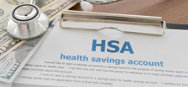 HSA paperwork with money on top.