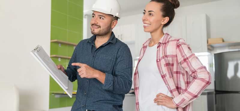 Home contractor talking with homeowner.