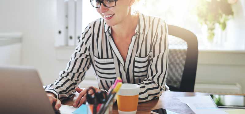 Young woman on her laptop in home office.