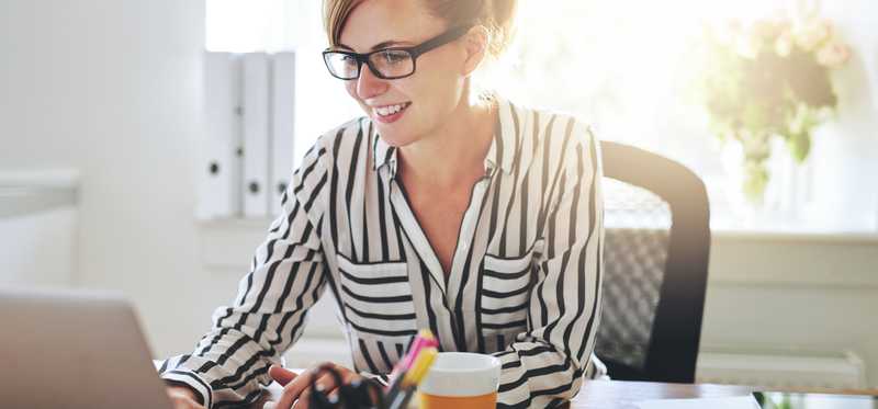 Young woman on her laptop in home office