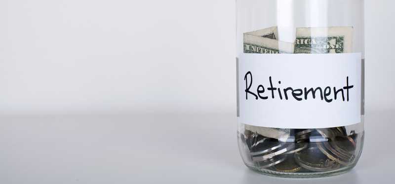 Jar labeled Retirement and half-filled with cash and coins