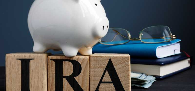 IRA letters with piggy bank book and glasses