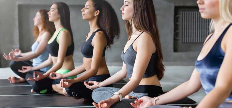A group of women attending yoga class.