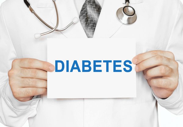 Physician holding up a paper reading Diabetes.