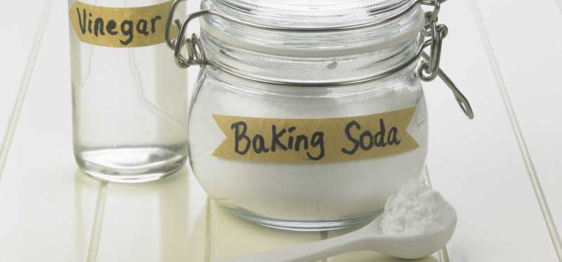 Glass containers labeled baking soda and vinegar.